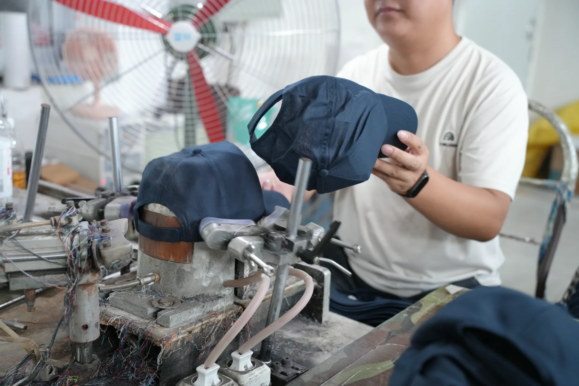 Cap shaping and finishing station